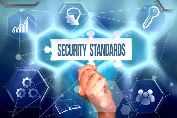 Text sign showing Security Standards. Word for the scope of security functions and features needed Hand Holding Jigsaw Puzzle Piece Unlocking New Futuristic Technologies.