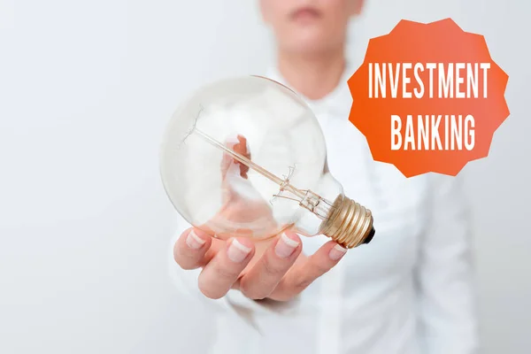 Text sign showing Investment Banking. Word for creation of capital for other companies or individuals Lady in business outfit holding lamp presenting new technology ideas — Stok fotoğraf