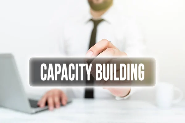 Sign displaying Capacity Building. Business concept Strengthen the abilities of individuals Workforce planning Remote Office Work Online Presenting Business Plan And Designs — Stock Photo, Image