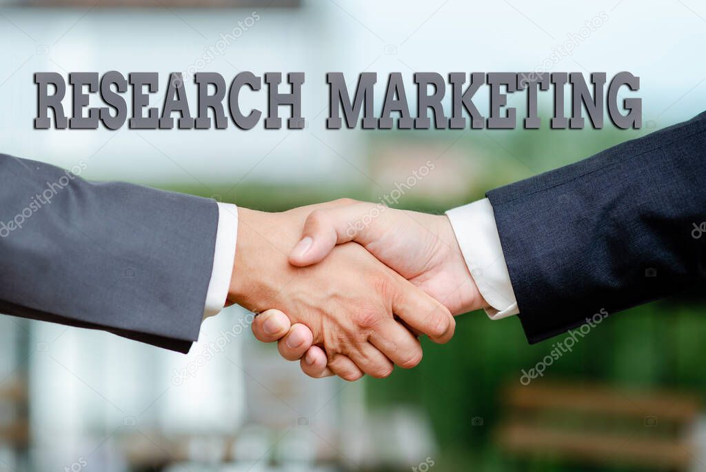 Writing displaying text Research Marketing. Business showcase process of gathering and interpreting info about a market Two Professional Well-Dressed Corporate Businessmen Handshake Indoors