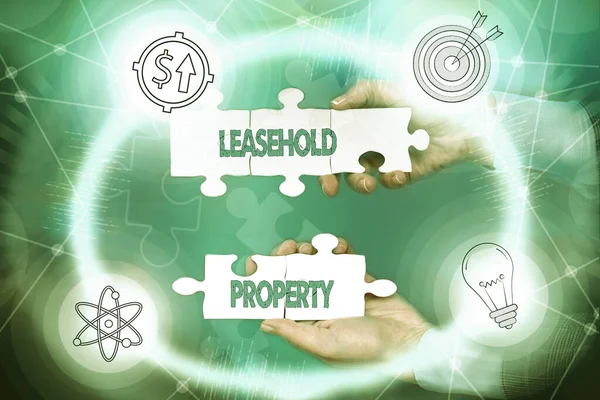 Text showing inspiration Leasehold Property. Business concept ownership of a temporary right to hold land or property Hand Holding Jigsaw Puzzle Piece Unlocking New Futuristic Technologies.