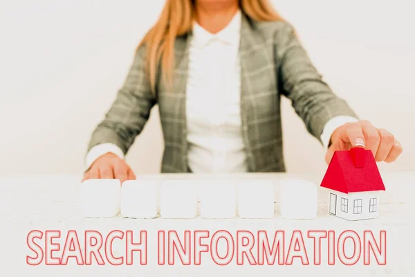 Text sign showing Search Information. Concept meaning the act or process of looking for someone or something A Young Lady Orbusinesswoman Holding Orpresenting Home In Business Outfit — 스톡 사진