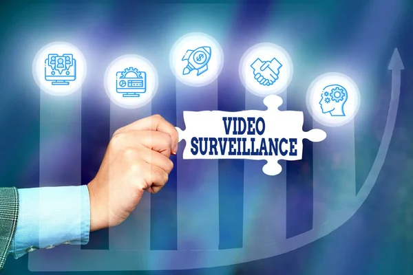 Conceptual caption Video Surveillance. Business showcase system of monitoring activity in an area or building Hand Holding Jigsaw Puzzle Piece Unlocking New Futuristic Technologies. — Stockfoto