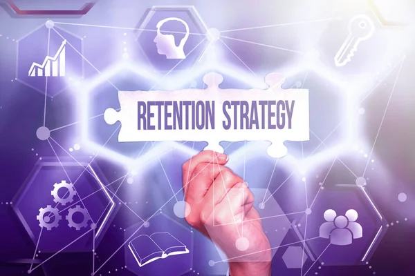 Text caption presenting Retention Strategy. Business concept activities to reduce employee turnover and attrition Hand Holding Jigsaw Puzzle Piece Unlocking New Futuristic Technologies. — Stock Photo, Image