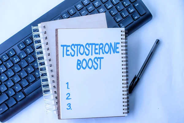 Text caption presenting Testosterone Boost. Conceptual photo rise of primary male sex hormone and an anabolic steroid Two Plain Lined Spiral Notebooks With Pen And Keyboard On Table.