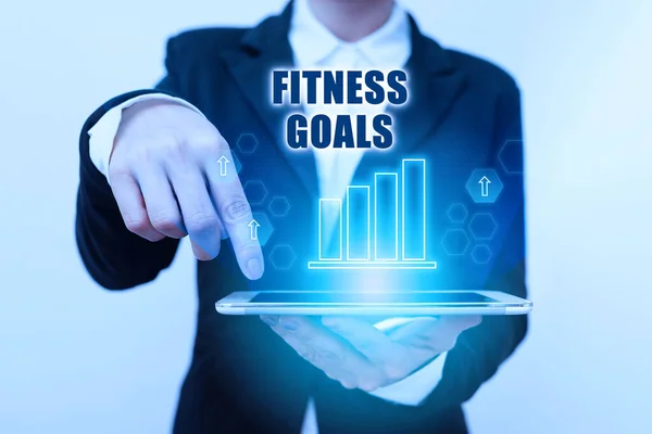 Sign displaying Fitness Goals. Business overview Loose fat Build muscle Getting stronger Conditioning Lady In Suit Pointing On Tablet Showing Futuristic Graphic Interface.