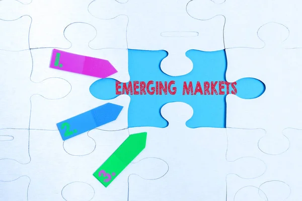 Conceptual display Emerging Markets. Business idea nations that are investing in more productive capacity Building An Unfinished White Jigsaw Pattern Puzzle With Missing Last Piece — 图库照片