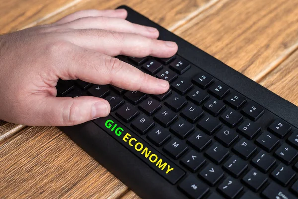 Text sign showing Gig Economy. Word for a market system distinguished by shortterm jobs and contracts Hands Pointing Pressing Computer Keyboard Keys Typewriting New Ideas. — Stock Photo, Image