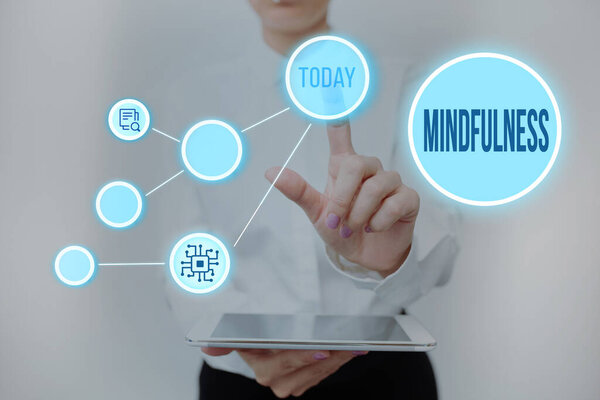 Hand writing sign Mindfulness. Internet Concept state of mind attained by concentrating one s is attention Lady Holding Tablet Pressing On Virtual Button Showing Futuristic Tech.