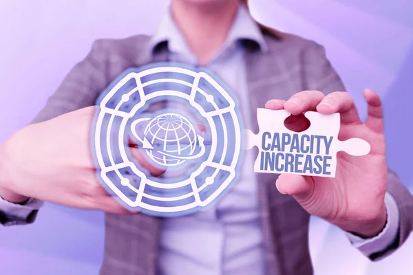 Inspiration showing sign Capacity Increase. Business showcase meet an actual increase in demand, or an anticipated one Business Woman Pointing Jigsaw Puzzle Piece Unlocking New Futuristic Tech. — Stock Photo, Image