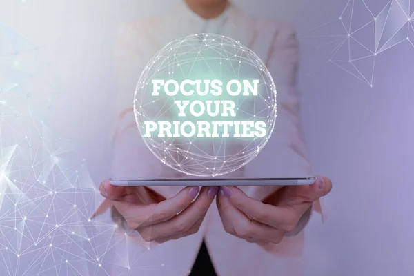 Conceptual caption Focus On Your Priorities. Business approach remove distractions Have a life plan Be a fortress Woman In Suit Holding Tablet With Circular Holographic Display. — Stock Photo, Image