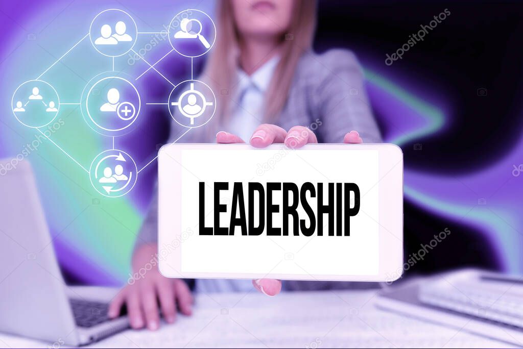 Sign displaying Leadership. Word for art of motivating to act toward achieving a common goal Business Woman Sitting In Office Holding Mobile Displaying Futuristic Ideas.
