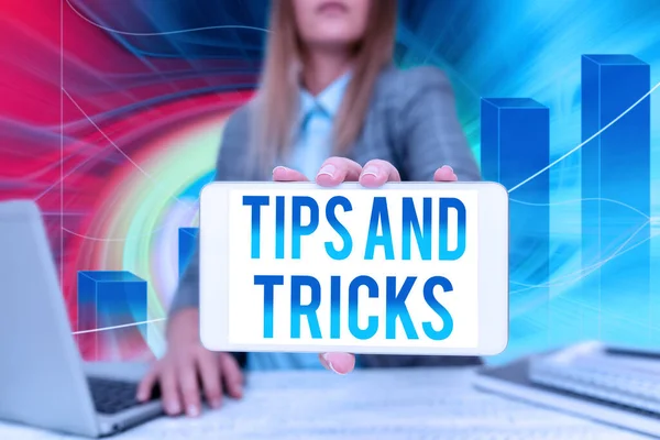 Text sign showing Tips And Tricks. Word for piece of inside facts specially in betting or investing Business Woman Sitting In Office Holding Mobile Displaying Futuristic Ideas. — 图库照片