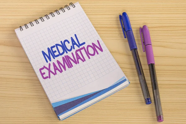 Hand writing sign Medical Examination. Business overview Checkup carried out to determine the physical fitness Multiple Assorted Collection Office Stationery Photo Placed Over Table — Stockfoto