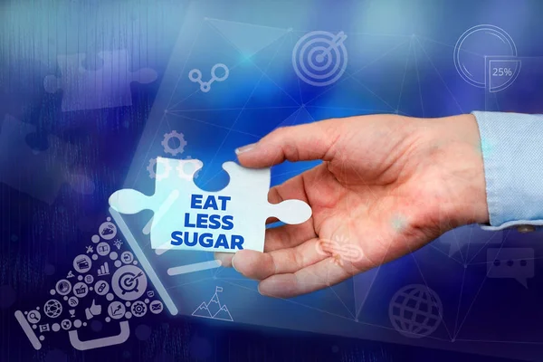 Text showing inspiration Eat Less Sugar. Conceptual photo reducing sugar intake and eating a healthful diet rich foods Hand Holding Jigsaw Puzzle Piece Unlocking New Futuristic Technologies. — Stock fotografie