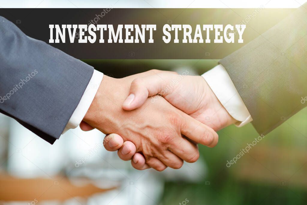 Inspiration showing sign Investment Strategy. Business approach the systematic plan to allocate investable assets Two Professional Well-Dressed Corporate Businessmen Handshake Indoors