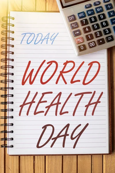 Πινακίδα που δείχνει Παγκόσμια Ημέρα Υγείας. Επιχειρηματική επισκόπηση παγκόσμια ημέρα ευαισθητοποίησης για την υγεία γιορτάζεται κάθε χρόνο στις 7 Απριλίου Blank Open Spiral Notebook With A Calculator Place On Table. — Φωτογραφία Αρχείου