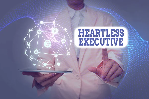 Handwriting text Heartless Executive. Business idea workmate showing a lack of empathy or compassion Lady In Uniform Holding Tablet In Hand Virtually Tapping Futuristic Tech.