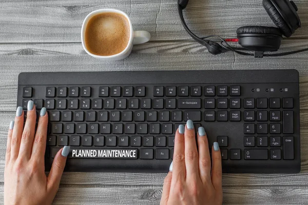 Text sign showing Planned Maintenance. Word for reventive maintenance carried out base on a fixed plan Keyboard Over A Table Beside A Ceramic Cup Filled With Hot Brew.