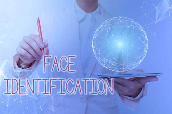 Conceptual display Face Identification. Word Written on analyzing patterns based on the person s is facial contours Woman In Suit Holding Tablet With Circular Holographic Display.