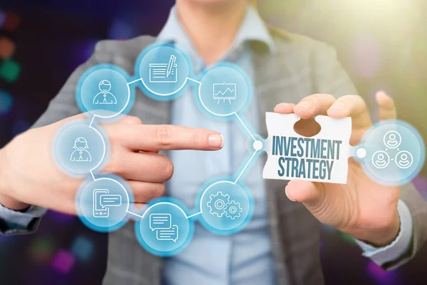 Text sign showing Investment Strategy. Business approach the systematic plan to allocate investable assets Business Woman Pointing Jigsaw Puzzle Piece Unlocking New Futuristic Tech. — Stock Photo, Image