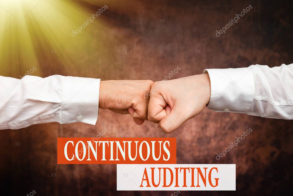 Text showing inspiration Continuous Auditing. Business showcase Internal process that examines accounting practices Two Professional Well-Dressed Corporate Businessmen Handshake Indoors