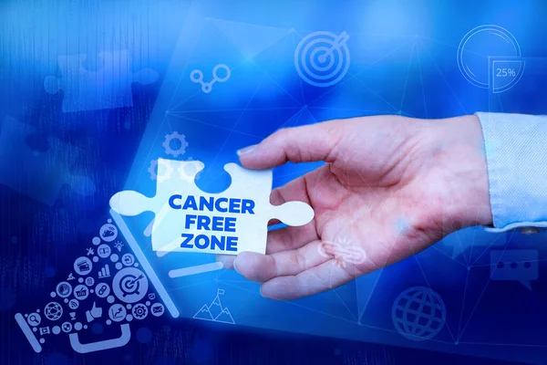 Text showing inspiration Cancer Free Zone. Internet Concept supporting cancer patients and raising awareness of cancer Hand Holding Jigsaw Puzzle Piece Unlocking New Futuristic Technologies.