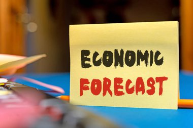 Sign displaying Economic Forecast. Word for attempting to predict the future condition of the economy Multiple Assorted Collection Office Stationery Photo Placed Over Table