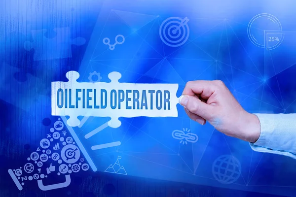 Sign displaying Oilfield Operator. Business approach responsible for optimizing production of the oil wells Hand Holding Jigsaw Puzzle Piece Unlocking New Futuristic Technologies. — Fotografia de Stock
