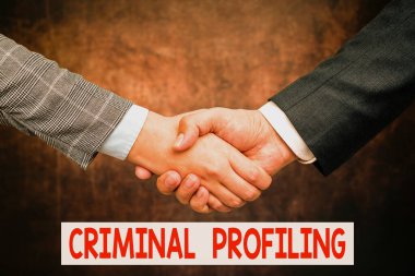 Writing displaying text Criminal Profiling. Business overview Develop profiles for criminals who not yet apprehended Two Professional Well-Dressed Corporate Businessmen Handshake Indoors