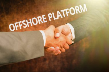 Text sign showing Offshore Platform. Concept meaning structure with facilities for well drilling to explore Two Professional Well-Dressed Corporate Businessmen Handshake Indoors