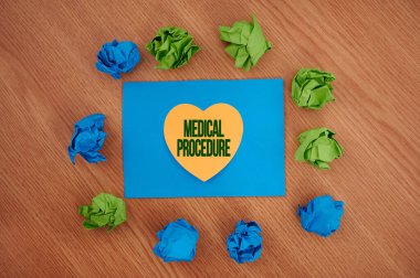 Hand writing sign Medical Procedure. Word for a procedure employed by medical or dental practitioners Colorful Crumpled Papers Circular Pattern Surrounding Heart Shaped Card.