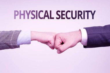 Text sign showing Physical Security. Business idea designed to deny unauthorized access to facilities Two Professional Well-Dressed Corporate Businessmen Handshake Indoors