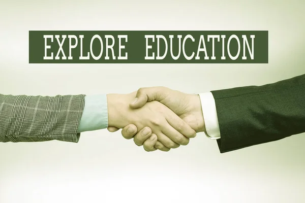 Text sign showing Explore Education. Business idea Discover the ways of acquiring knowledge or skills Two Professional Well-Dressed Corporate Businessmen Handshake Indoors