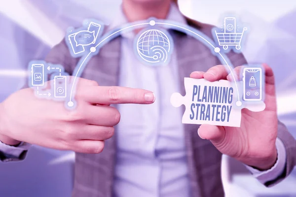 Sign displaying Planning Strategy. Conceptual photo systematic process of envisioning a desired future Business Woman Pointing Jigsaw Puzzle Piece Unlocking New Futuristic Tech. — Stockfoto