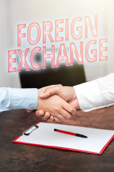 Conceptual display Foreign Exchange. Concept meaning system for dealing in the currency of other countries Two Professional Well-Dressed Corporate Businessmen Handshake Indoors — ストック写真