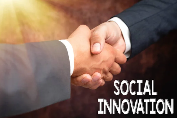 Text sign showing Social Innovation. Business overview practices that aim to meet social needs in a better way Two Professional Well-Dressed Corporate Businessmen Handshake Indoors