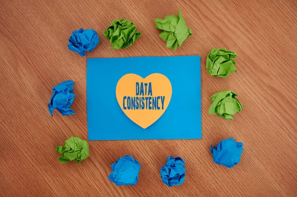 Inspiration showing sign Data Consistency. Concept meaning data values are the same for all instances of application Colorful Crumpled Papers Circular Pattern Surrounding Heart Shaped Card. — Photo