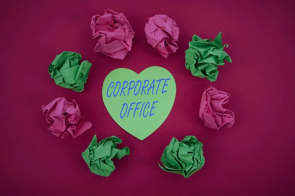 Sign displaying Corporate Office. Business approach central location for planning and execution of a business Colorful Crumpled Papers Circular Pattern Surrounding Heart Shaped Card. — 스톡 사진