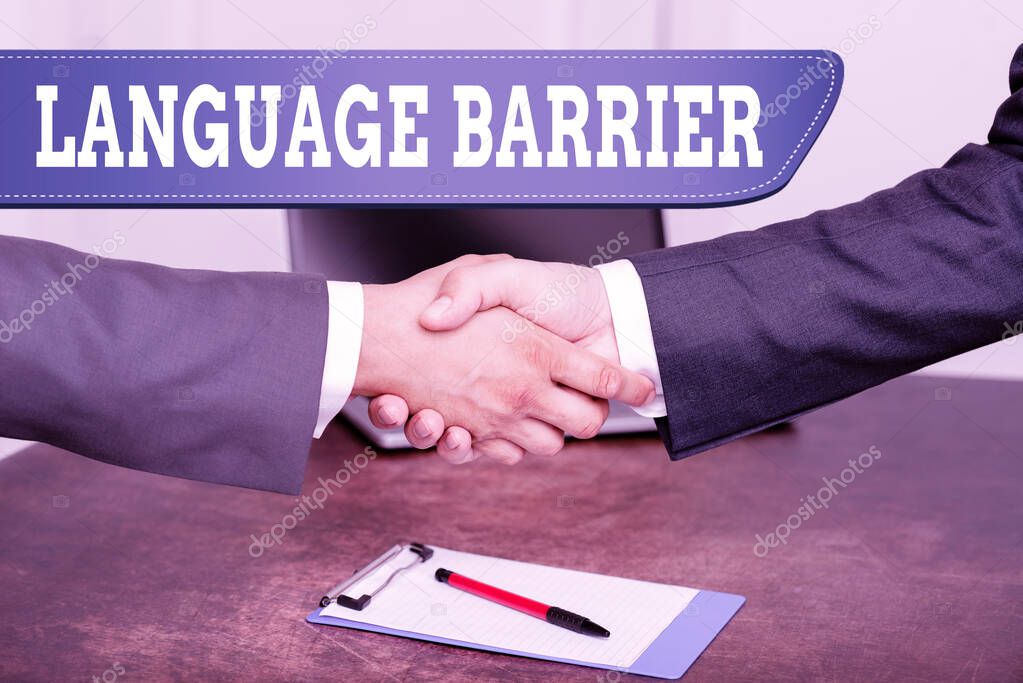Hand writing sign Language Barrier. Word Written on difficulties in communication Speaking different language Two Professional Well-Dressed Corporate Businessmen Handshake Indoors