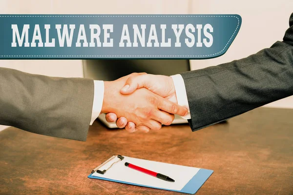 Hand writing sign Malware Analysis. Business approach performs deep analysis of evasive and unknown threats Two Professional Well-Dressed Corporate Businessmen Handshake Indoors — 图库照片