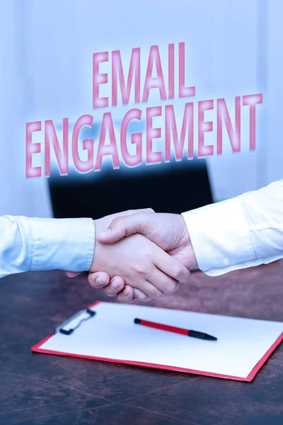Conceptual caption Email Engagement. Business idea measure how subscribers engage in the email campaigns Two Professional Well-Dressed Corporate Businessmen Handshake Indoors — 图库照片