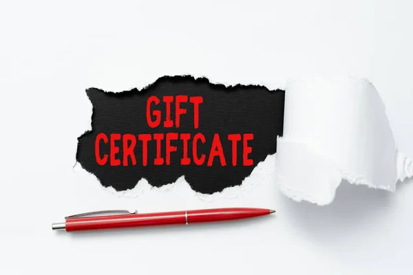 Text sign showing Gift Certificate. Conceptual photo certificate entitling the recipient to receive goods Tear on sheet reveals background with pen on board — 图库照片