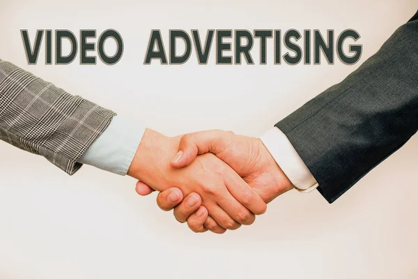 Text showing inspiration Video Advertising. Business overview encompasses online display advertisements that have video Two Professional Well-Dressed Corporate Businessmen Handshake Indoors