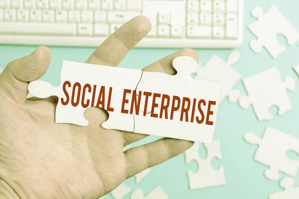 Text sign showing Social Enterprise. Word Written on commercial organization that has specific social objective Building An Unfinished White Jigsaw Pattern Puzzle With Missing Last Piece — Stock Photo, Image