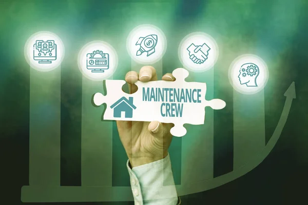 Writing displaying text Maintenance Crew. Business approach responsible for maintenance and repair work of buildings Hand Holding Jigsaw Puzzle Piece Unlocking New Futuristic Technologies.
