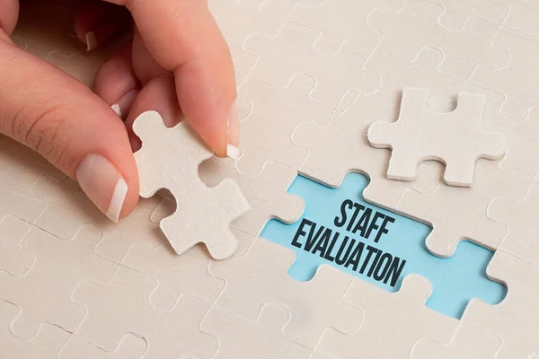 Conceptual caption Staff Evaluation. Business approach assessment and review of a worker s is job performance Building An Unfinished White Jigsaw Pattern Puzzle With Missing Last Piece — Stock Photo, Image