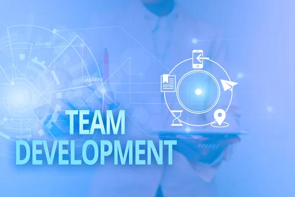 Text caption presenting Team Development. Business approach the enhancement of the effectiveness of work groups Woman In Uniform Standing Holding Tablet Showing Futuristic Interface. — Stock Photo, Image