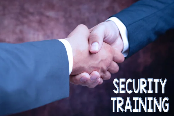 Hand writing sign Security Training. Word for providing security awareness training for end users Two Professional Well-Dressed Corporate Businessmen Handshake Indoors — Stock Photo, Image