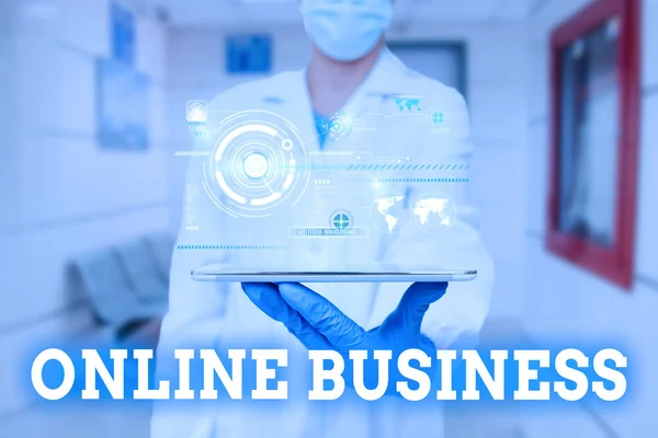 Text sign showing Online Business. Business idea kind of business activity that happens over the internet Man In Uniform Standing Holding Tablet Showing Medical Futuristic Tech. — Stock Photo, Image